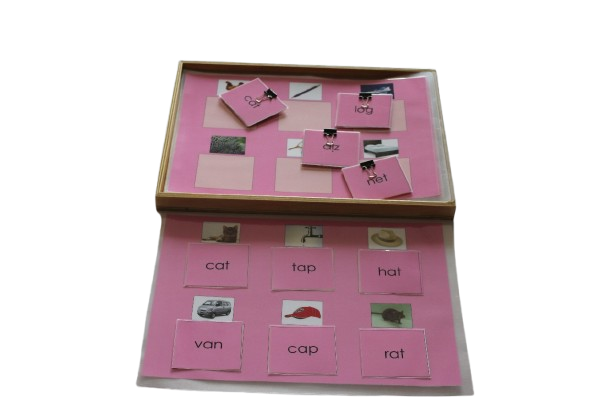 PINK SHEETS OF PICTURES AND CARDS(WOODEN BOX WITH  A4 SIZE SHEETS  EACH SHEET CONTAINING 6 PICTURES PERTAINING TO VOWELS SOUNDS "A,E,I,O,U" WITH CORRESPONDING NAME TAG)